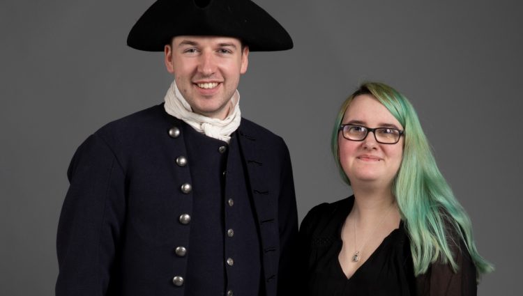 Rowan on the left and a man on the right, who is wearing a costume Rowan made. They are both looking at the camera and smiling.