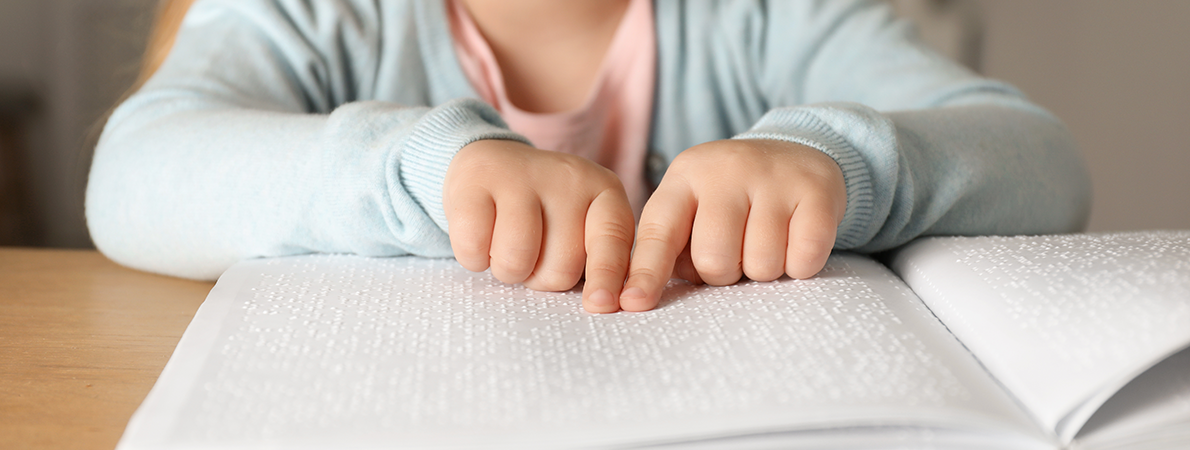 Blind child reading braille