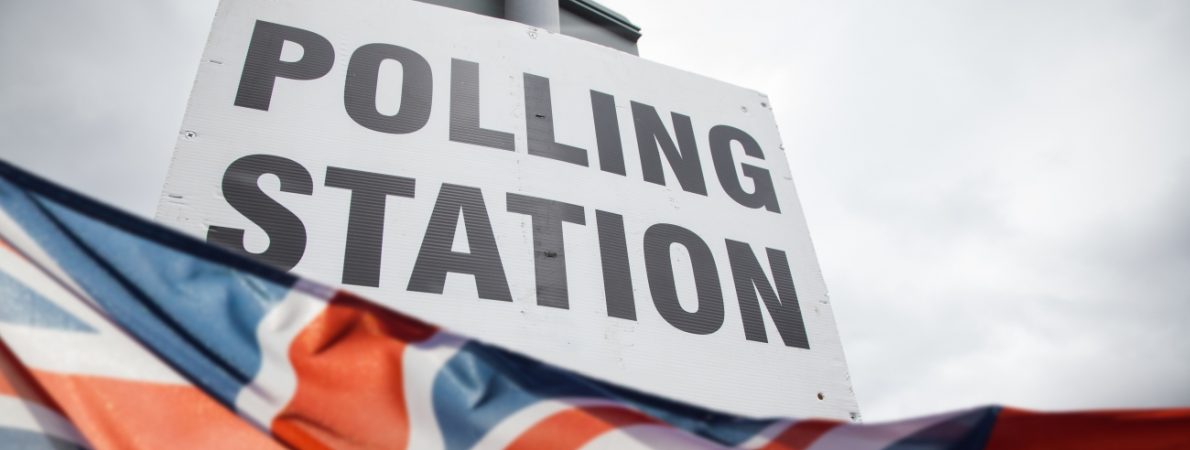 A sign that says 'Polling station' and the Union Jack flag underneath