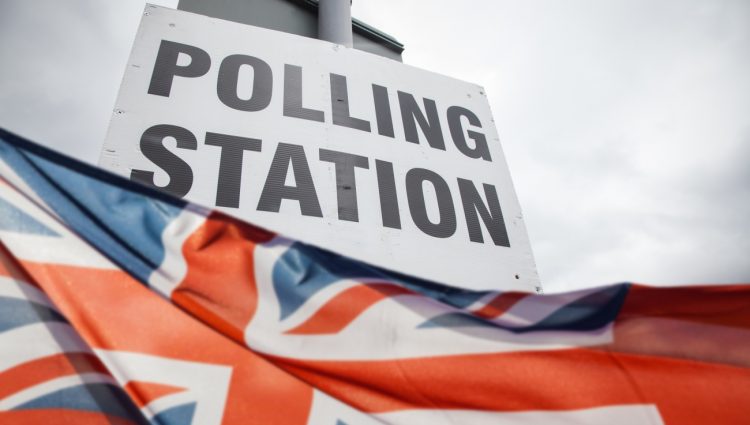 A sign that says 'Polling station' and the Union Jack flag underneath
