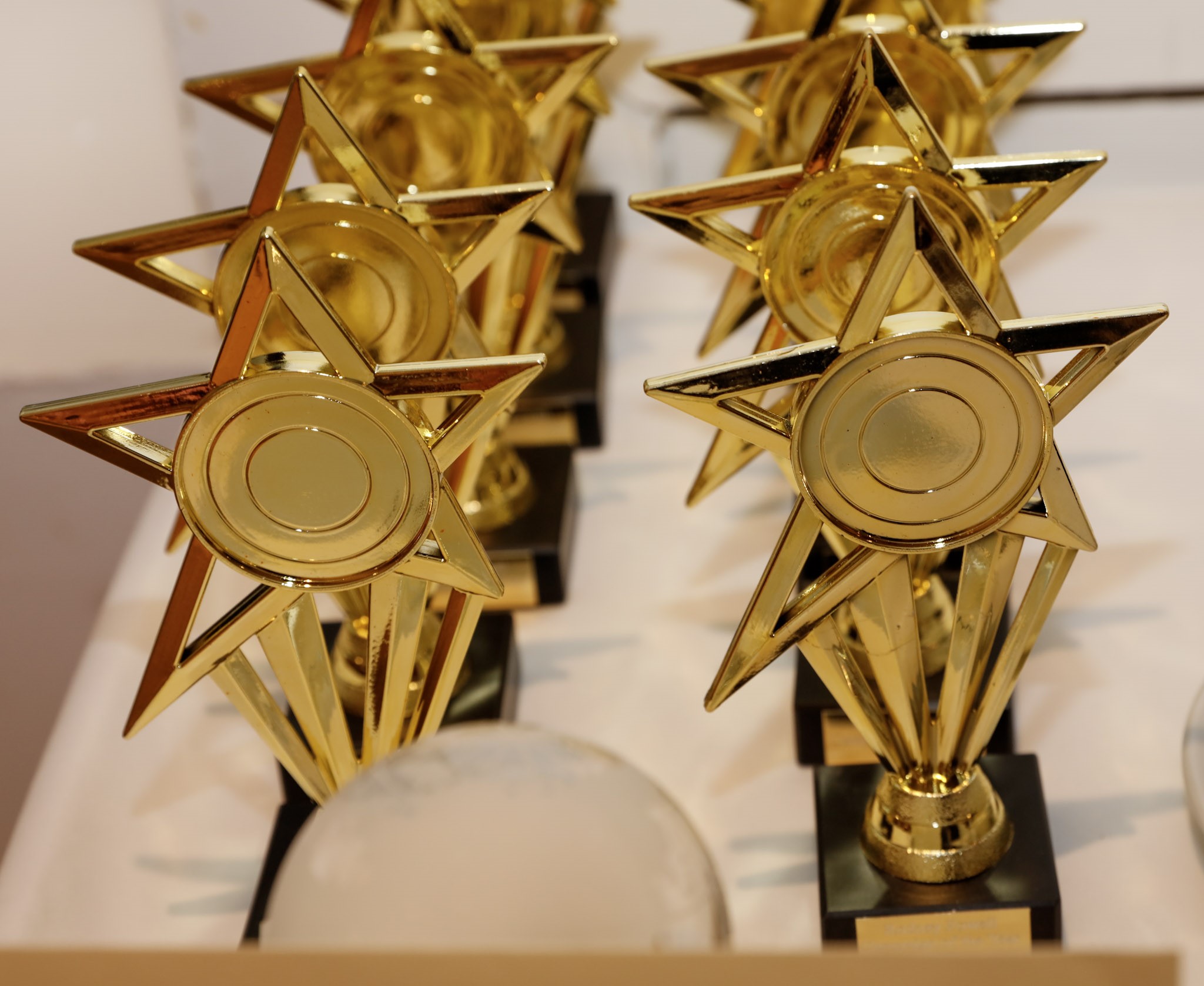 Two rows of golden, star shaped, Rodney Powell Awards.